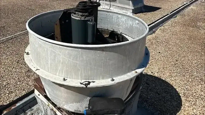 The fan housing is open, exposing the motor and drive assembly.