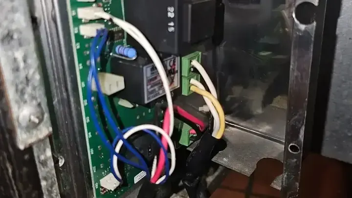An open equipment compartment shows a circuit board, connectors and wiring.
